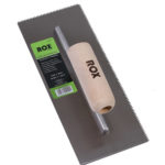 Image-of-a-ROX-Contractor-Range-carpet-adhesive-trowel-with-a-V-notch-edge-featuring-a-high-carbon-steel-rectangular-blade-and-a-wooden-handle-labeled-with-the-ROX-logo-A-green-and-black-product-label-is-affixed-to-the-blade-detailing-the-trowels-specifications-3mm-x-3mm-notches-and-280mm-x-115mm-blade-size