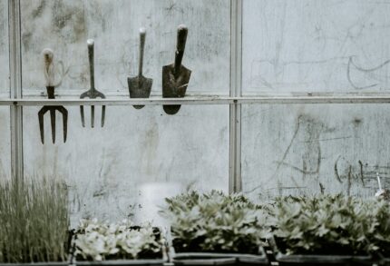 A gauging trowel hung on a window with other various equipment.