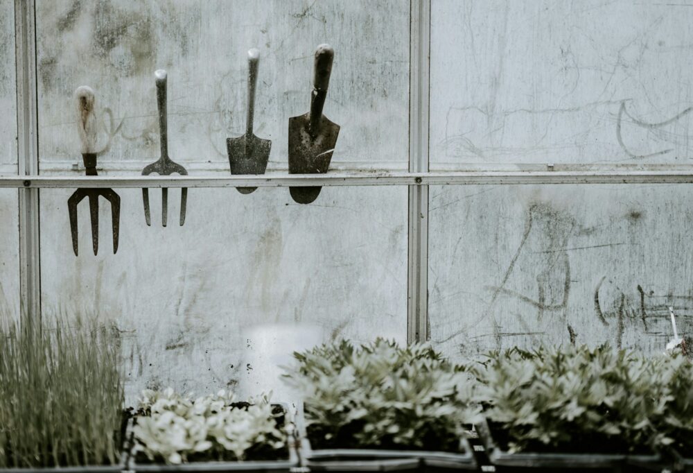 A gauging trowel hung on a window with other various equipment.